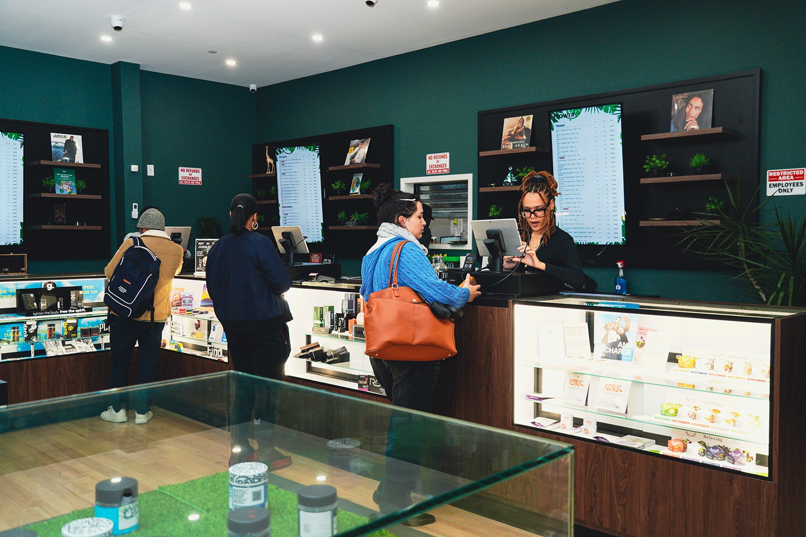 Customers at the counter inside Jungle Kingdom Flower dispensary in Bed-Stuy Brooklyn