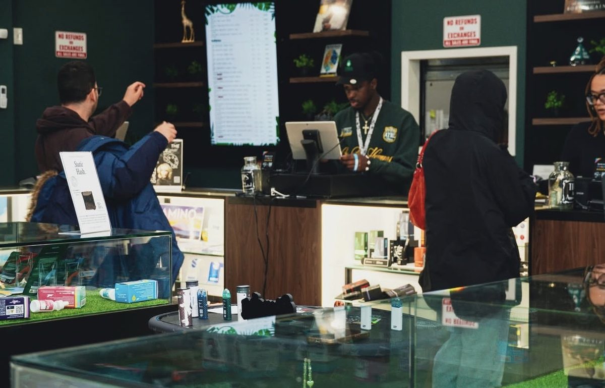 Budtenders helping customers at Jungle Kingdom Flower dispensary in Bed-Stuy Brooklyn